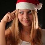 Christmas girl point finger to cap